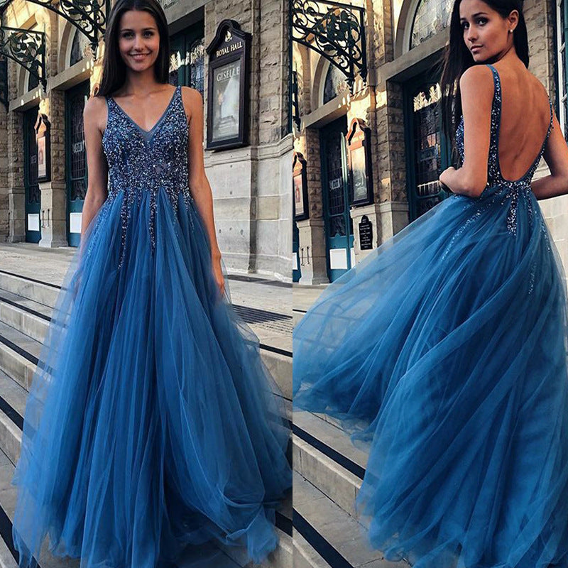 Woman wearing a blue evening gown with a city street background