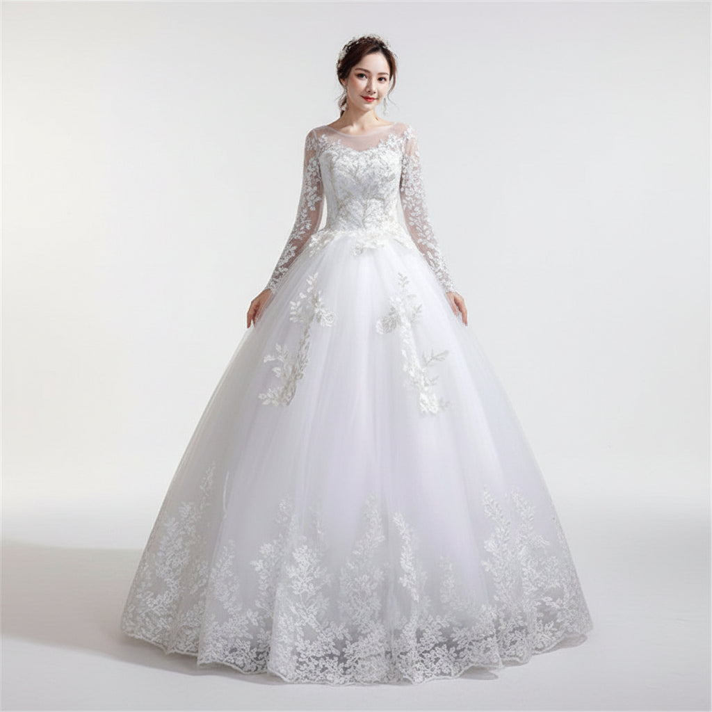 Woman wearing a white lace wedding dress against a textured wall.