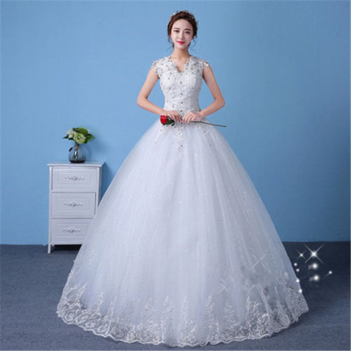 Woman in a white wedding dress holding flowers against a blue background