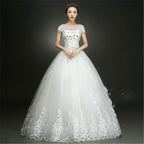 White wedding dress with lace details on a dark background