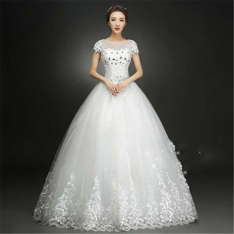 White wedding dress with lace details on a dark background