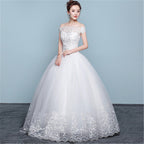 White wedding dress with lace details on a plain background