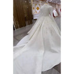 White wedding dress with intricate detailing in a store setting