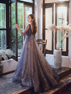 Woman in a sparkly dress standing in a room with large windows and decorative plants.