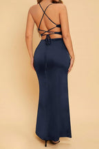 Navy blue dress with criss-cross back design on a beige background
