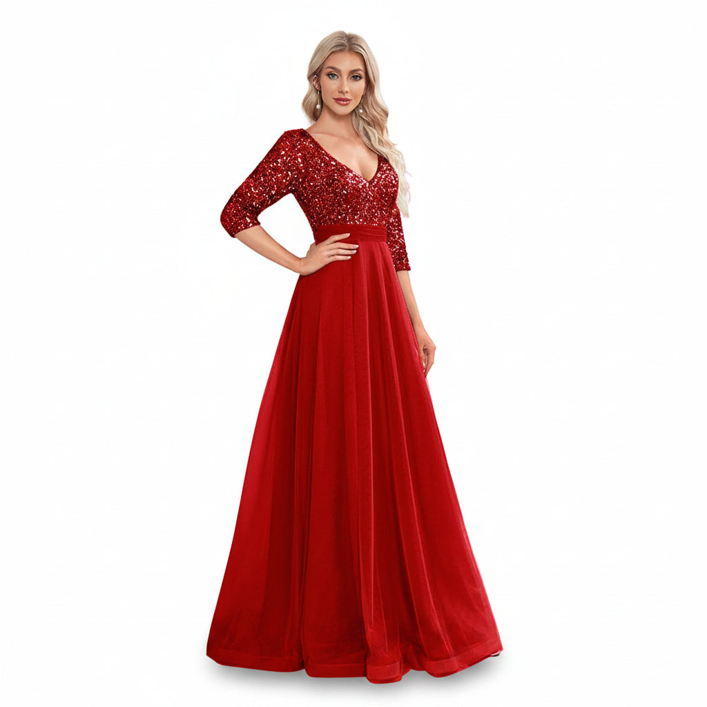 Woman wearing a red evening gown with sequin details in a room.