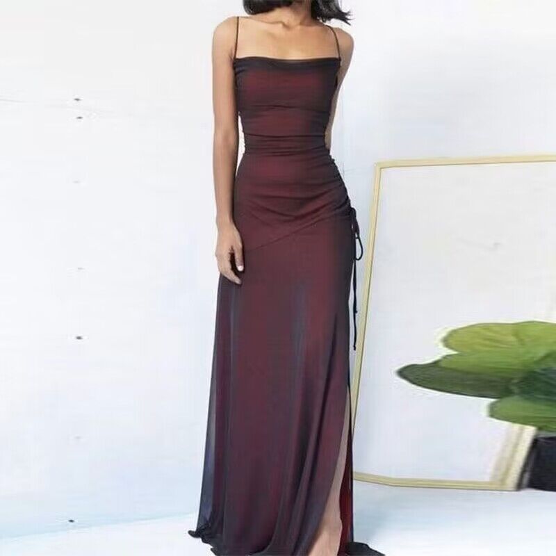 Burgundy evening gown with a slit on a white background