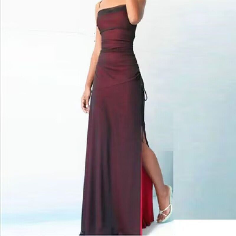Burgundy strapless gown with a high slit on a light blue background