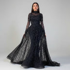 Black sheer evening gown with long sleeves and a flowing skirt on a neutral background