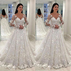 Woman in a white floral wedding dress standing in front of a mirror.
