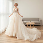 Woman in a white wedding dress standing in a room with wooden floor and white walls.