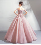 Pink evening gown with floral details on a plain background