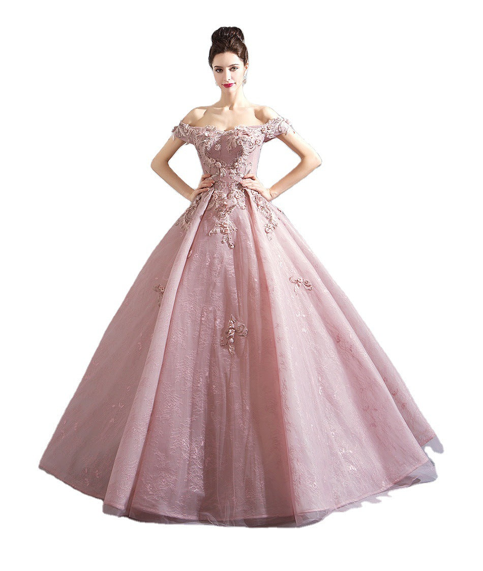 Pink evening gown with floral embroidery on a white background