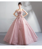 Pink evening gown with floral embroidery on a plain background