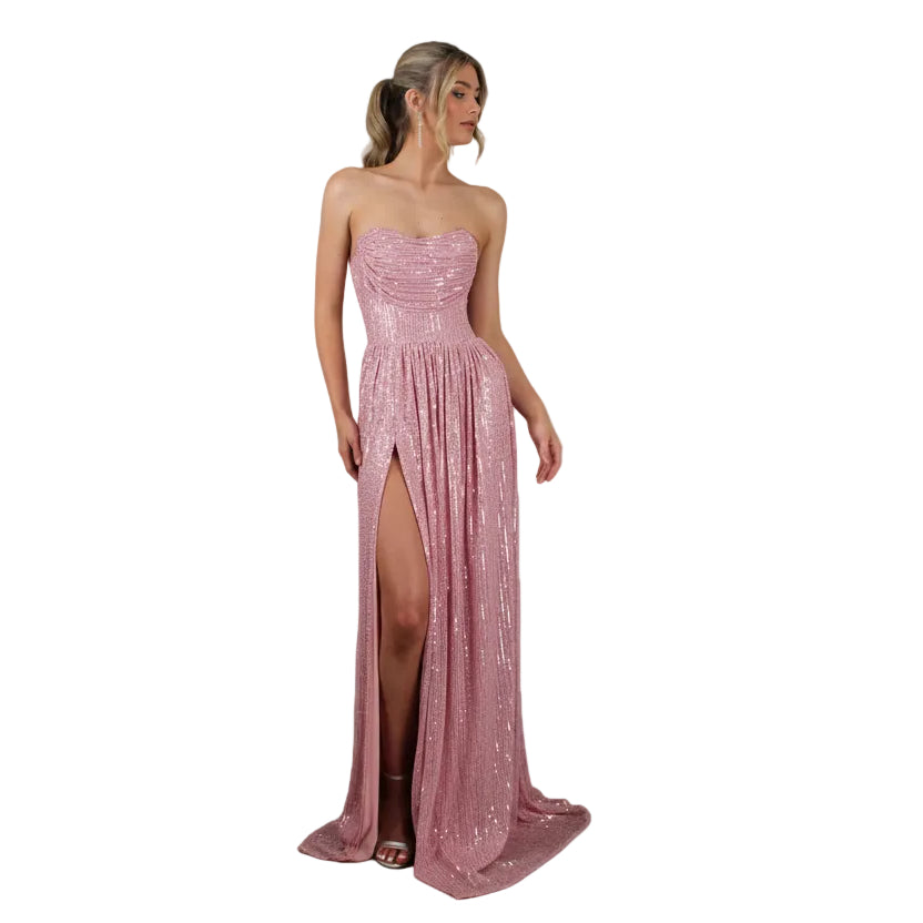 Pink strapless evening gown with a high slit on a white background