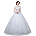 White wedding dress with lace details on a plain background