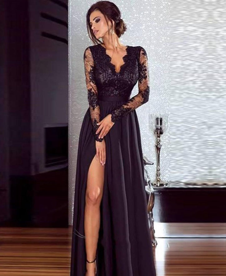 Woman wearing a black lace evening gown in an indoor setting.